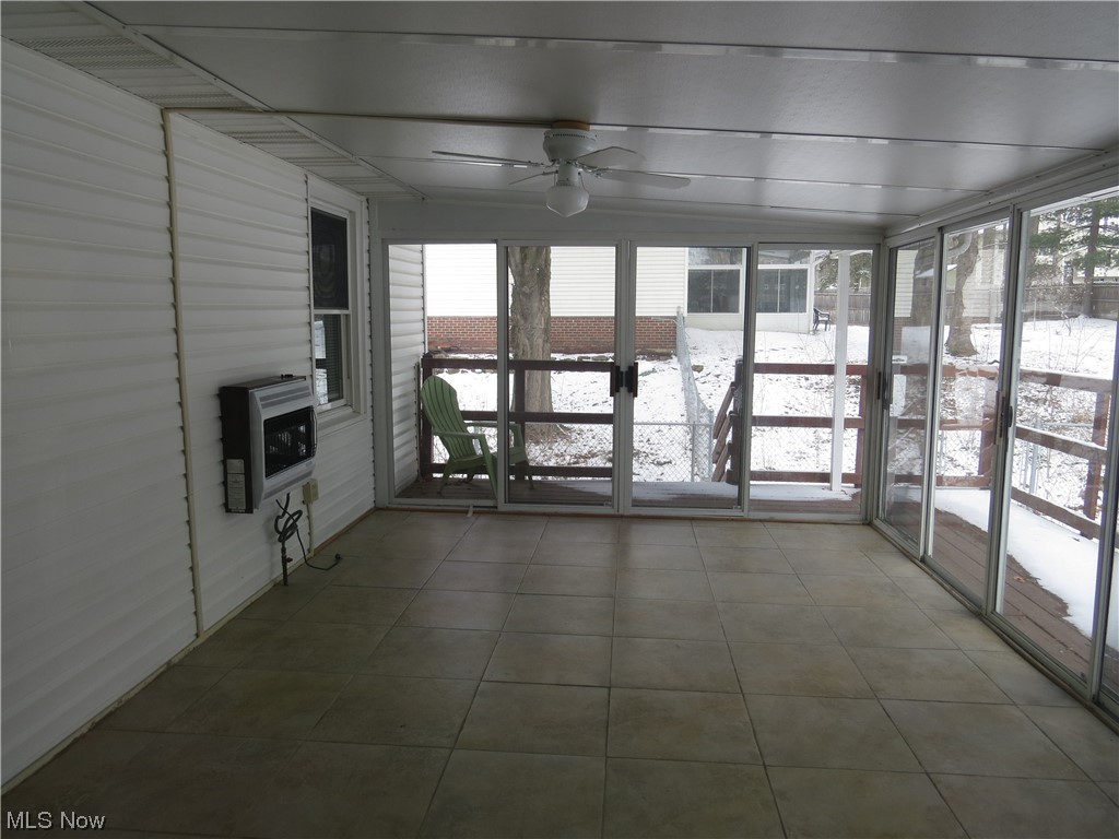 641 Schocalog Road Akron, OH 44320 - Photo 21 of 33 4 Season room with wall gas heater, natural light and ceiling fan