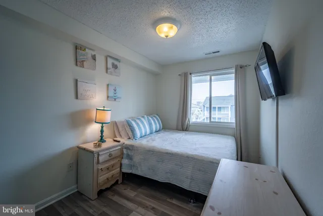 a bedroom with a bed and flat screen tv