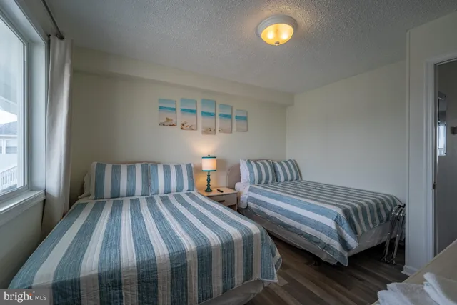 a bedroom with two beds and a window