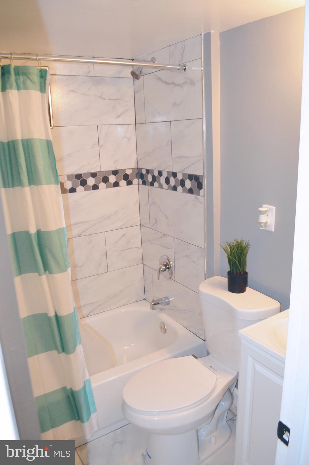 203 Mountain Road Linthicum, MD 21090 - Photo 12 of 17 a bathroom with a sink and a mirror