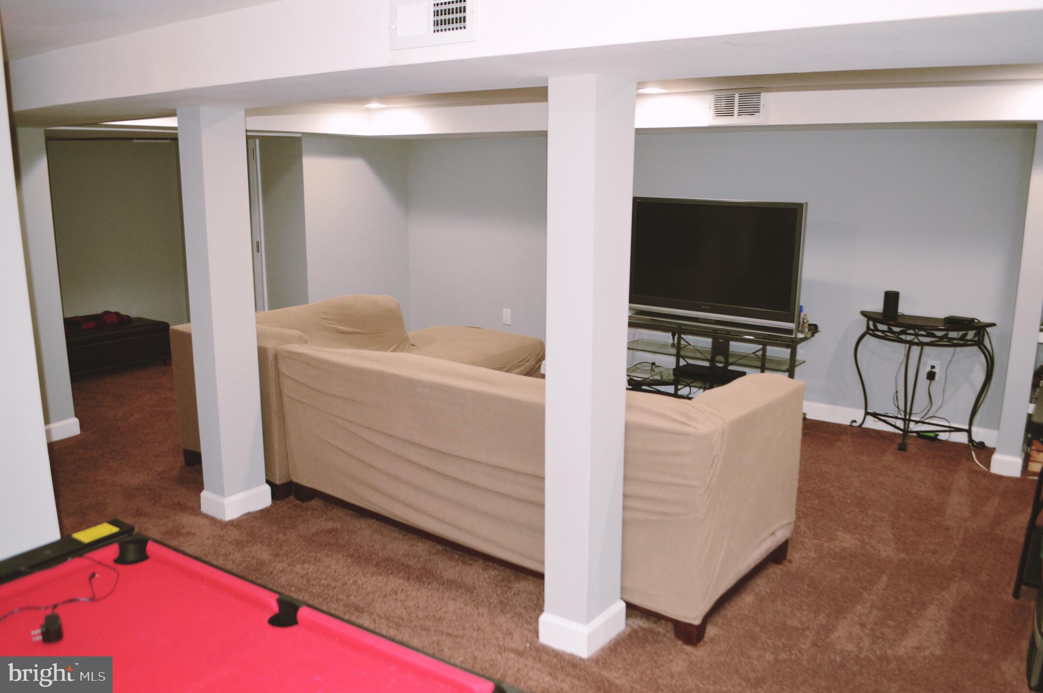 203 Mountain Road Linthicum, MD 21090 - Photo 14 of 17 a bedroom with a bed and a flat screen tv