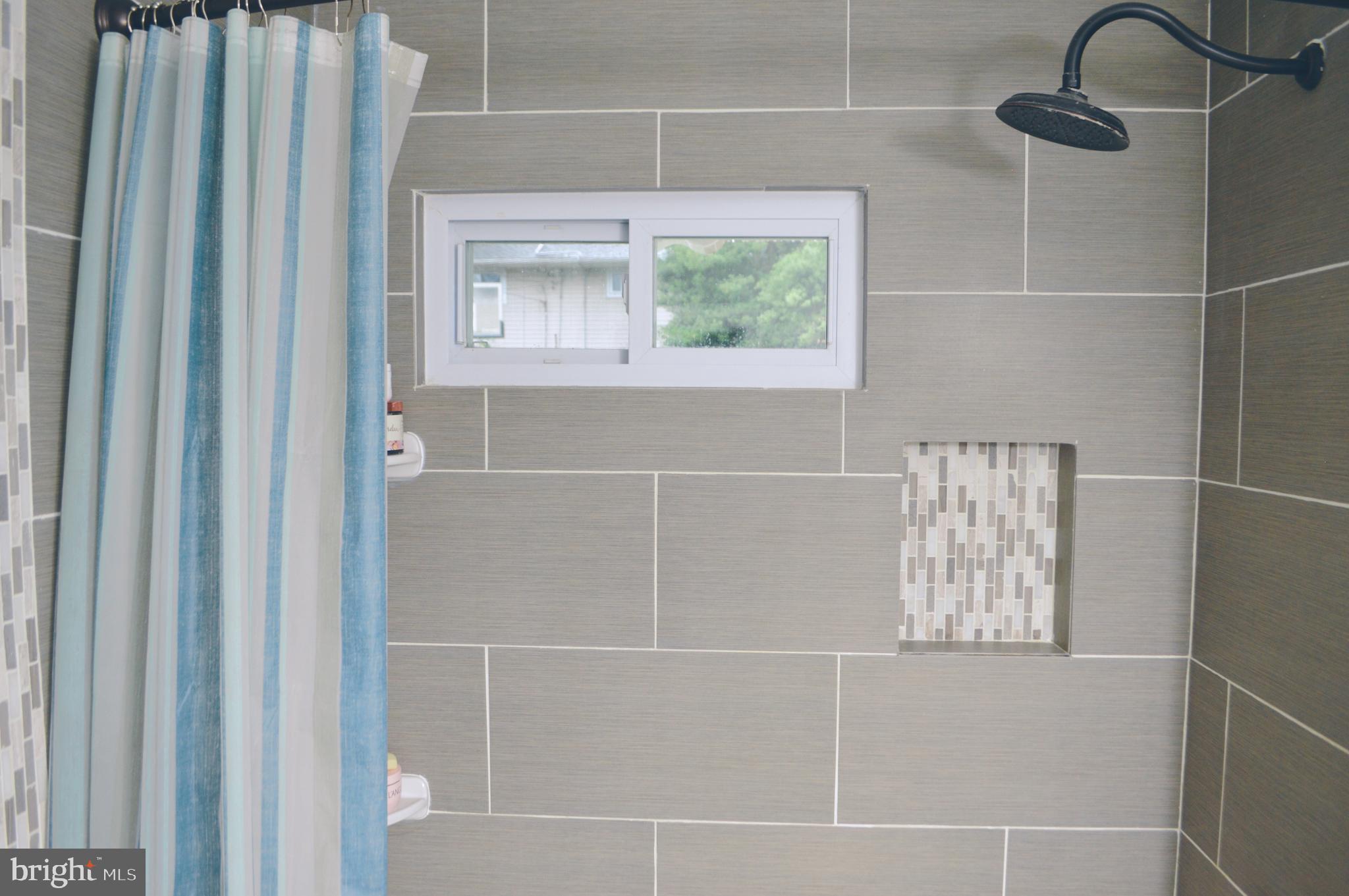203 Mountain Road Linthicum, MD 21090 - Photo 16 of 17 a bathroom with a window and a shower