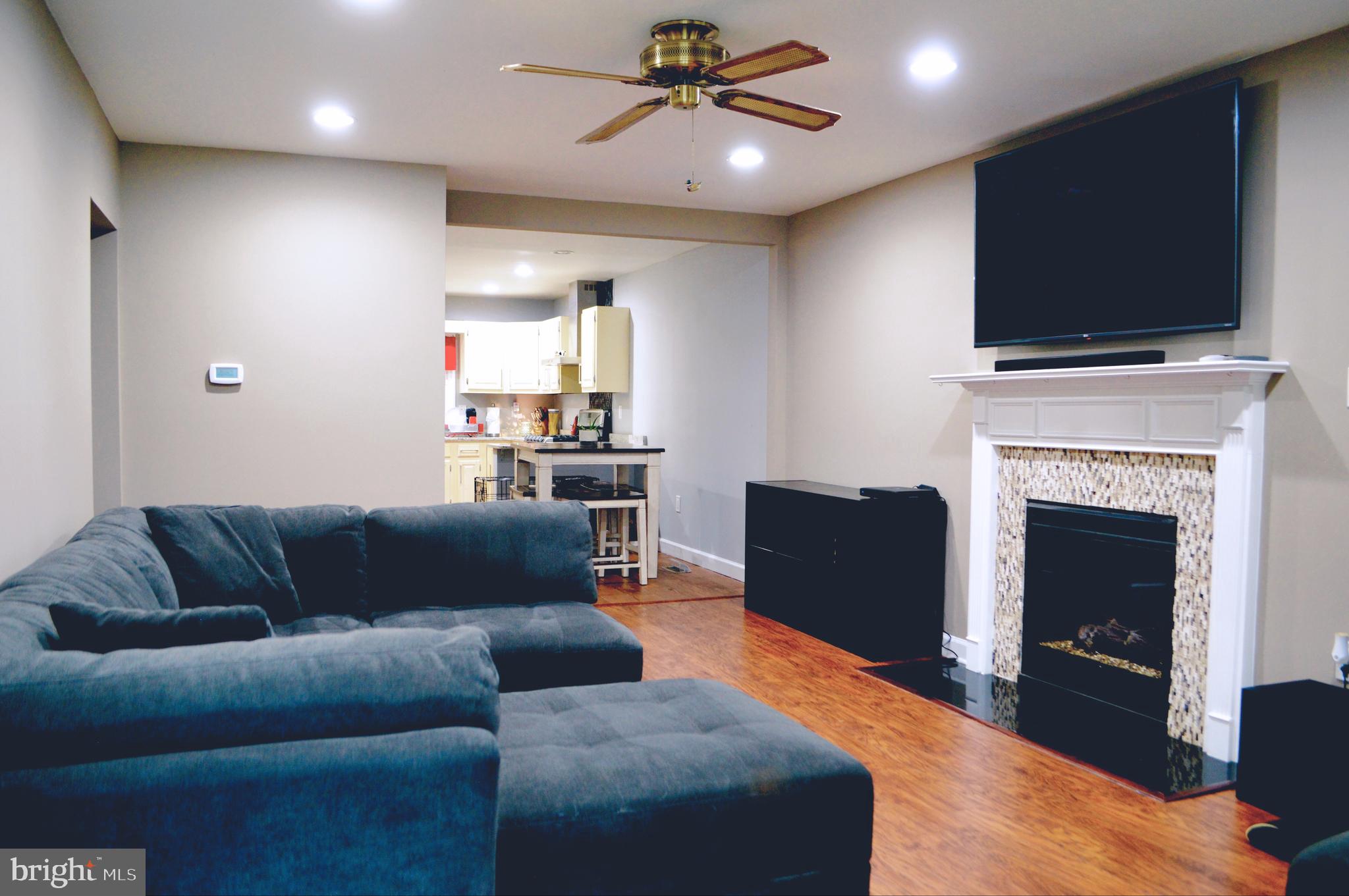203 Mountain Road Linthicum, MD 21090 - Photo 3 of 17 a living room with furniture a flat screen tv and a fireplace
