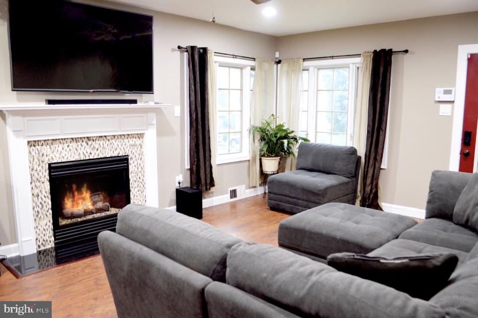 203 Mountain Road Linthicum, MD 21090 - Photo 4 of 17 a living room with furniture a flat screen tv and a fireplace