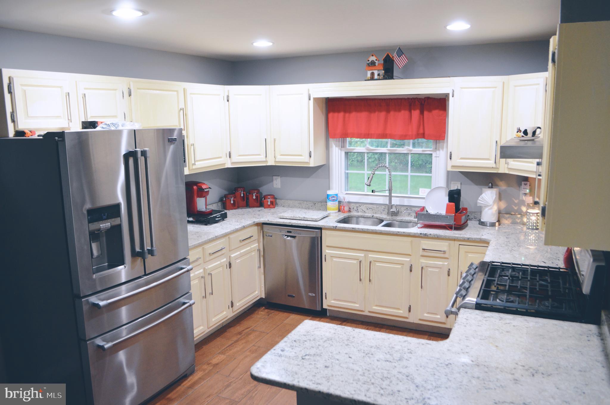 203 Mountain Road Linthicum, MD 21090 - Photo 8 of 17 a kitchen with stainless steel appliances granite countertop a refrigerator sink and stove