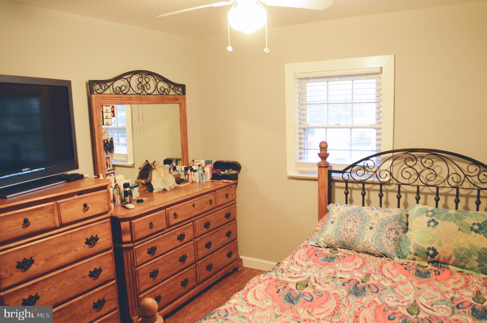 203 Mountain Road Linthicum, MD 21090 - Photo 9 of 17 a bedroom with a bed and a flat tv screen on dresser