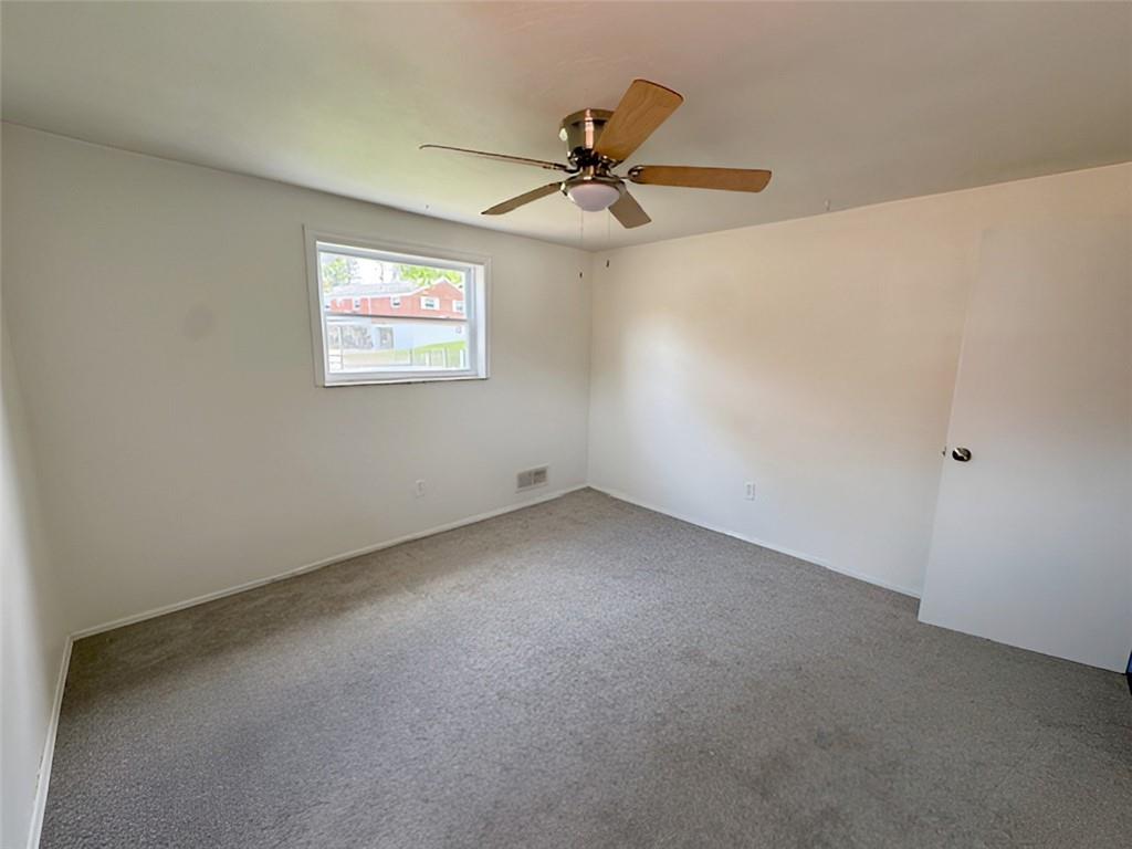 279 Olympic Road Pittsburgh, PA 15236 - Photo 17 of 25 an empty room with a window and a fan