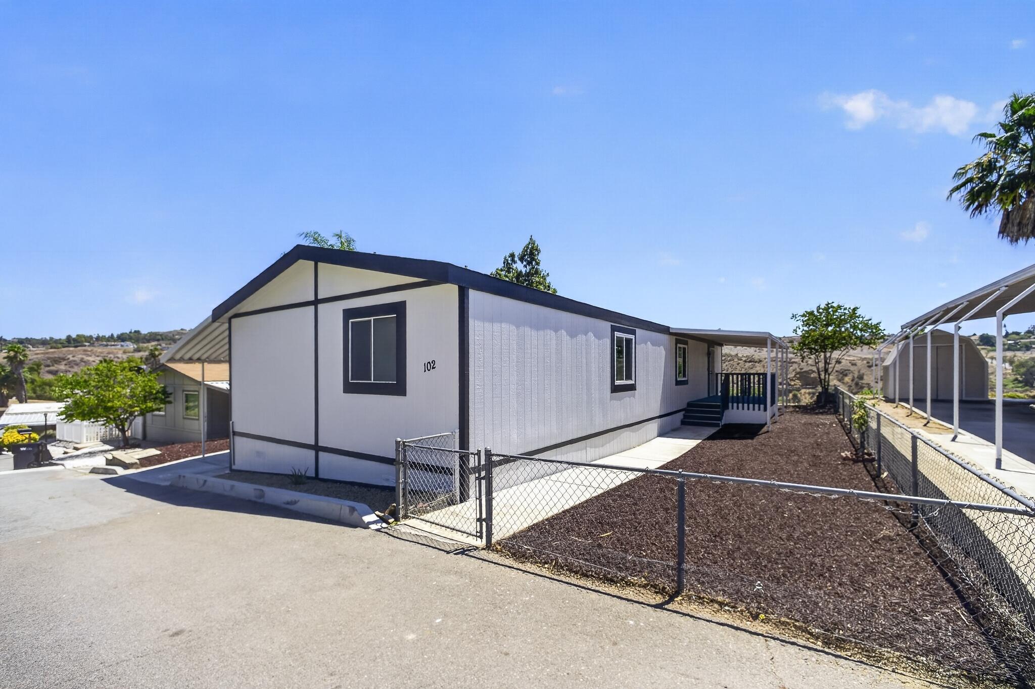 15181 Van Buren Boulevard, Unit 102 Riverside, CA 92504 - Photo 29 of 29 a view of a house with backyard and a tree
