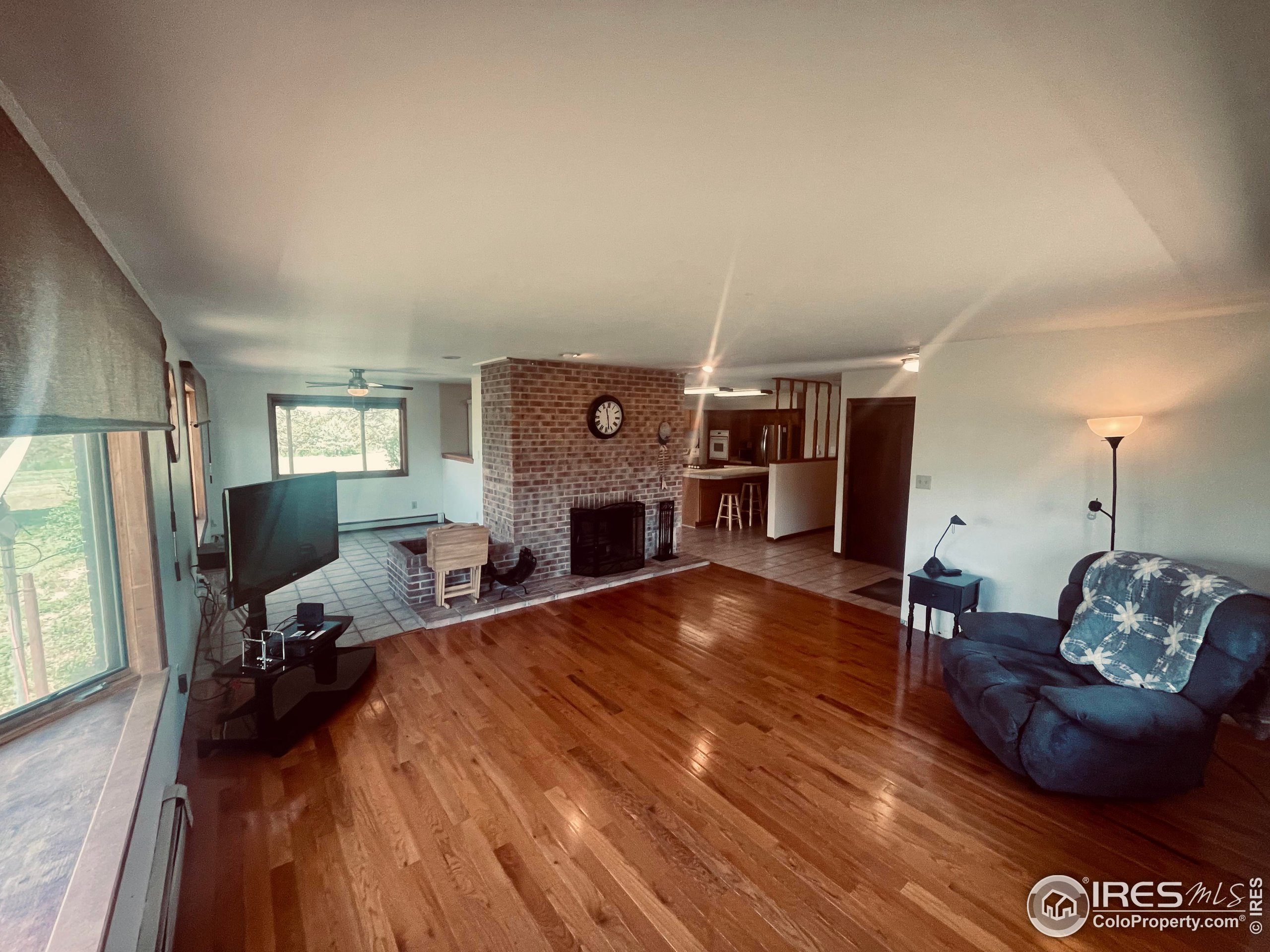 9485 County Road 15 Firestone, CO 80504 - Photo 11 of 15 a living room with furniture and a fireplace