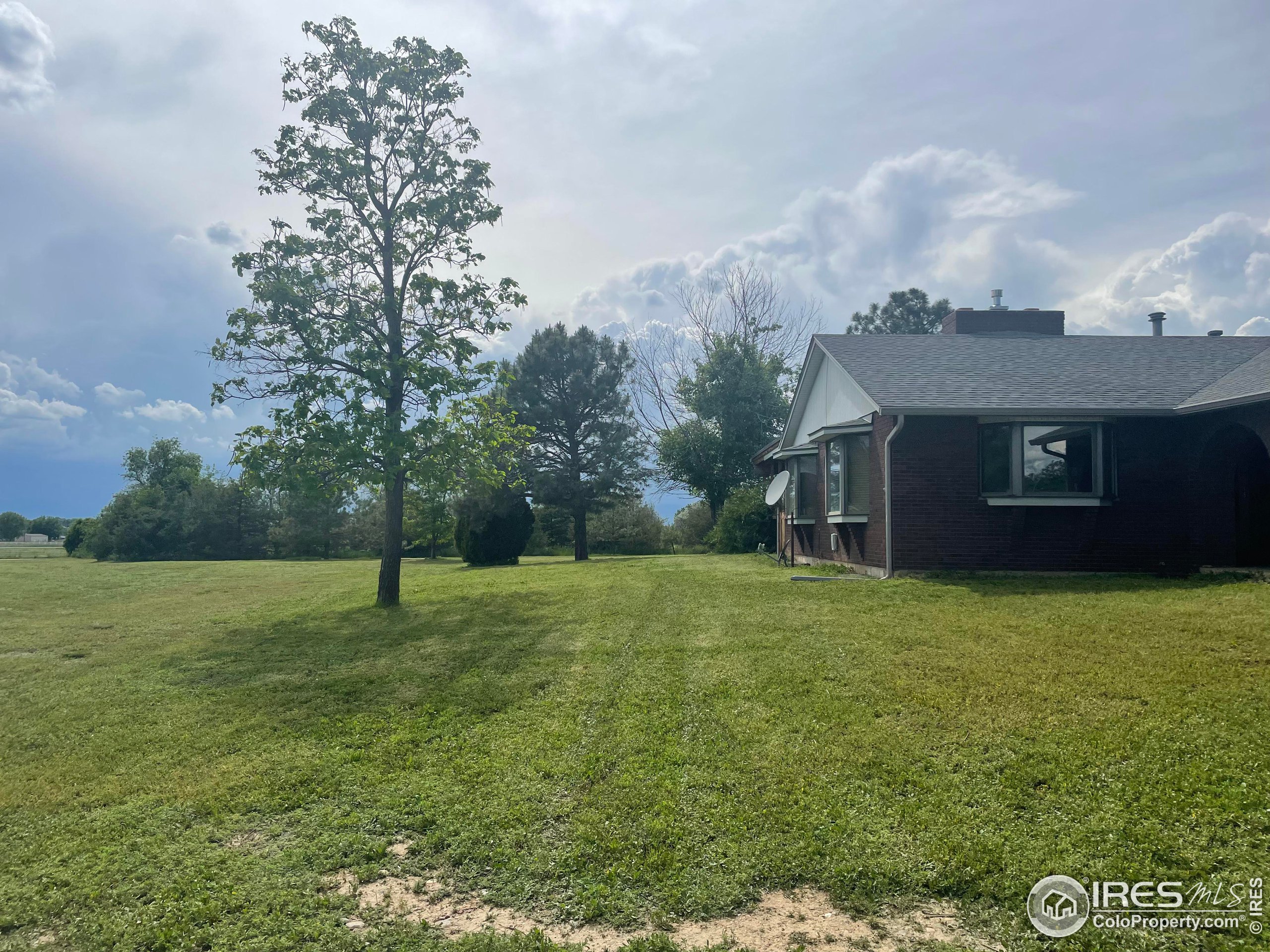 9485 County Road 15 Firestone, CO 80504 - Photo 2 of 15 a backyard of a house with lots of green space