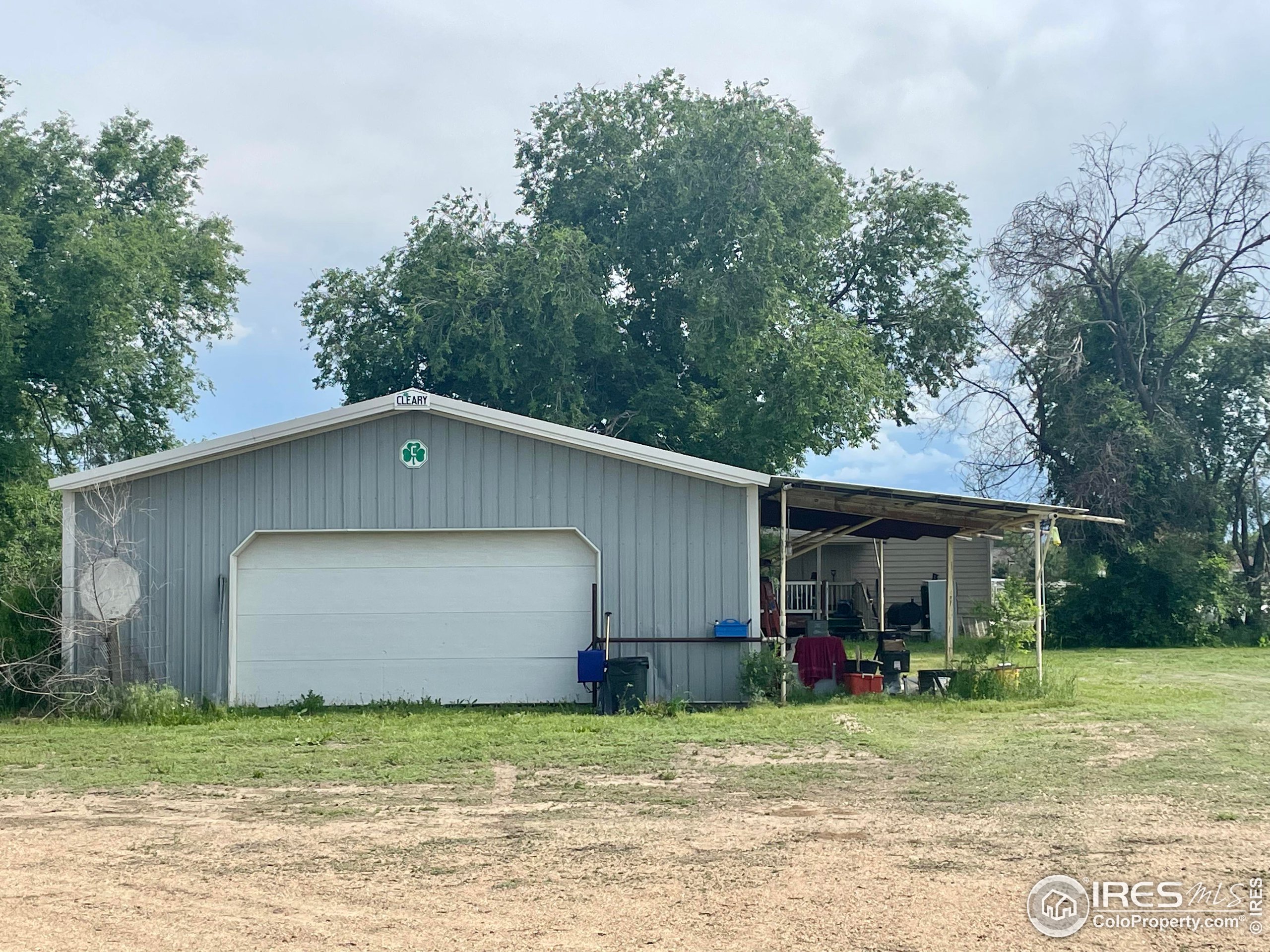 9485 County Road 15 Firestone, CO 80504 - Photo 9 of 15 a house with a yard and a large tree
