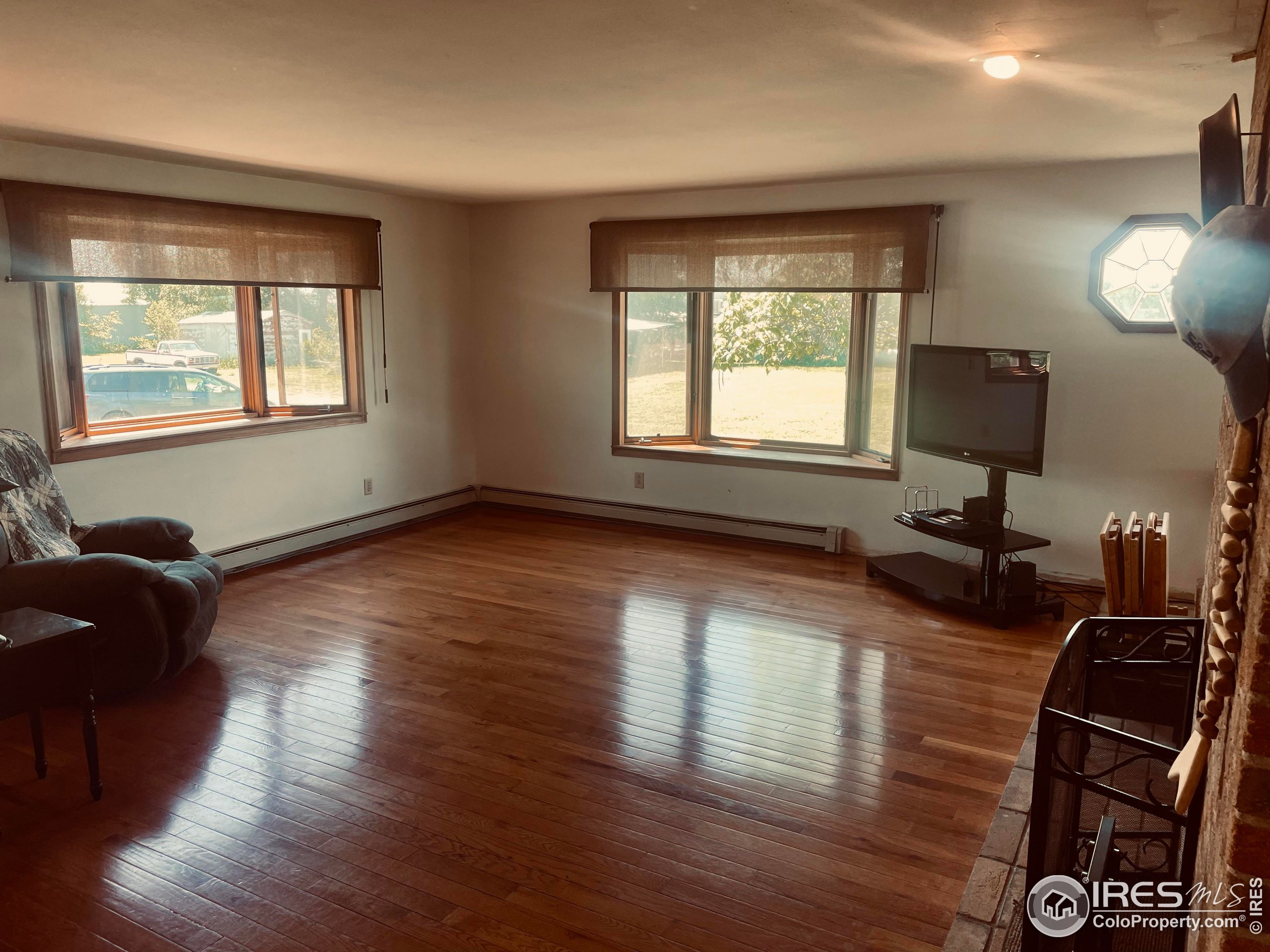 9485 County Road 15 Firestone, CO 80504 - Photo 10 of 15 a living room with hard wood floors and a window