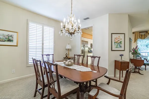 a view of a dining room with furniture and window
