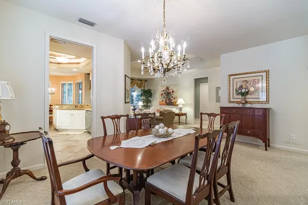 a view of a dining room with furniture and chandelier