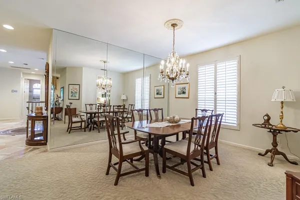 a view of a dining room with furniture and chandelier