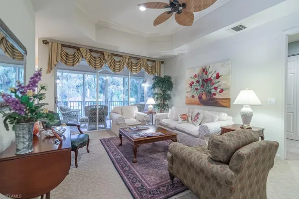 a living room with furniture and flowers