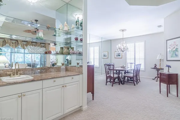 a kitchen with cabinets and chairs