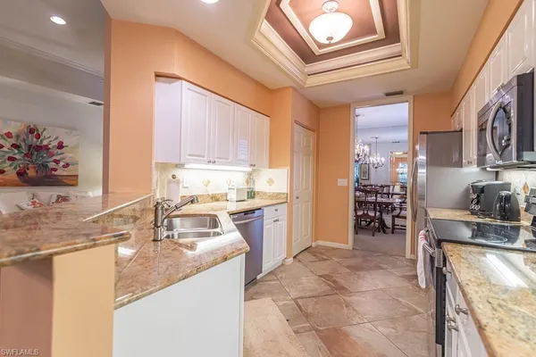 a kitchen with a sink appliances and cabinets