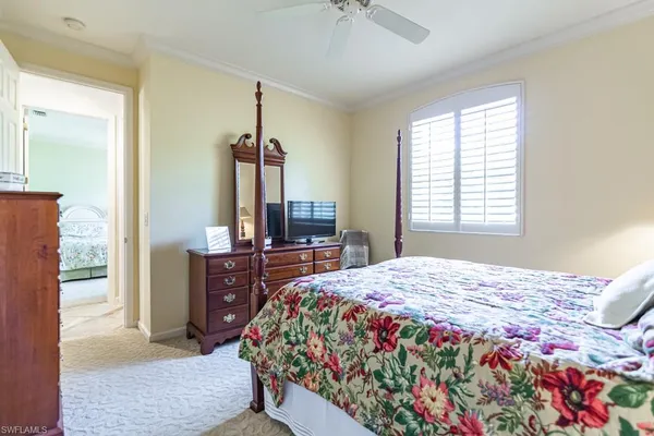a bedroom with a bed dresser and a window