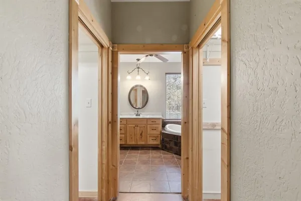a bathroom with a glass shower door and a mirror