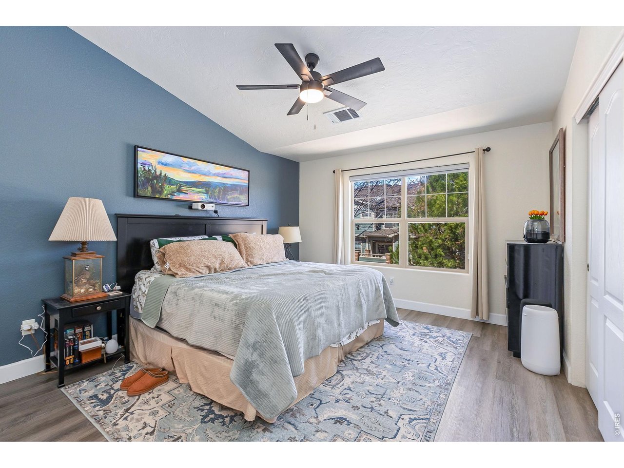 5775 29th Street, Unit 811 Greeley, CO 80634 - Photo 11 of 21 a bedroom with a bed and a table with a chandelier