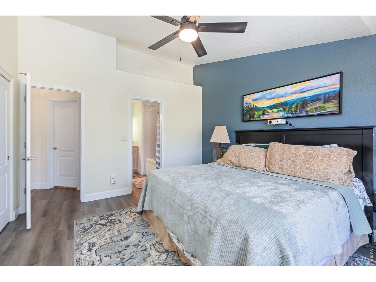 5775 29th Street, Unit 811 Greeley, CO 80634 - Photo 12 of 21 a bedroom with a bed and a chandelier