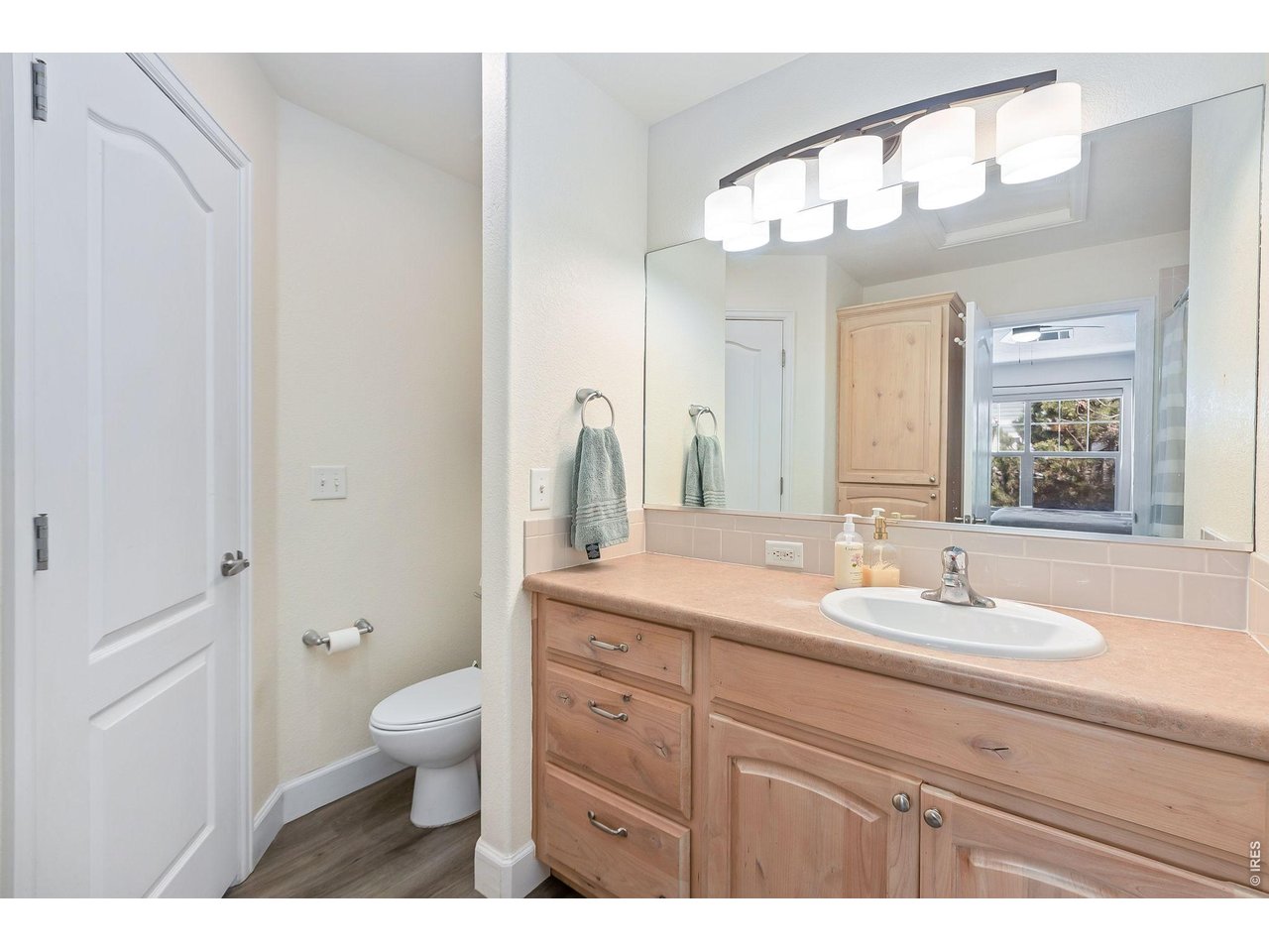 5775 29th Street, Unit 811 Greeley, CO 80634 - Photo 16 of 21 a bathroom with a granite countertop sink a toilet and a mirror