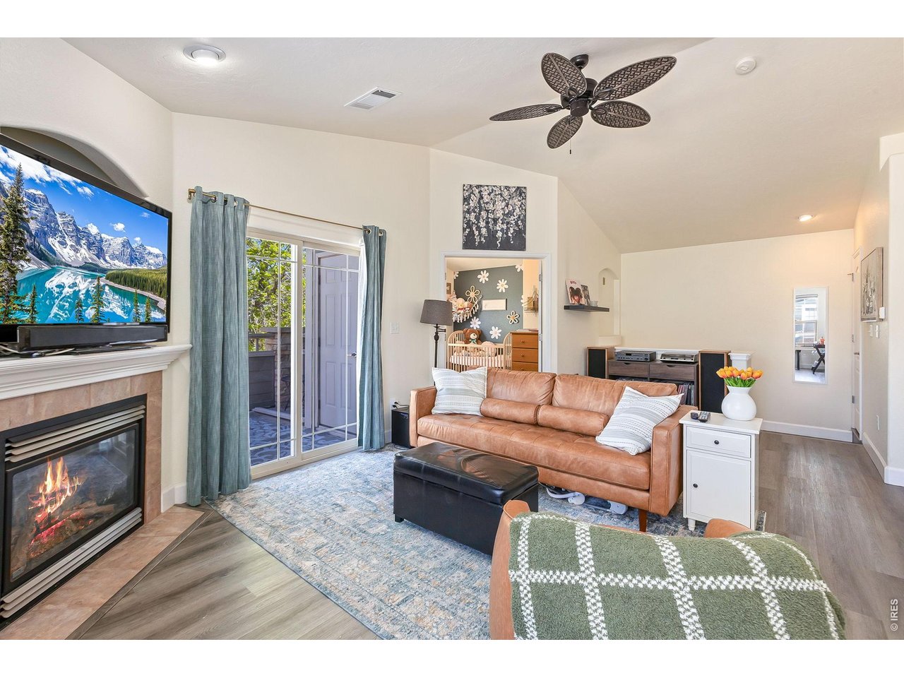 5775 29th Street, Unit 811 Greeley, CO 80634 - Photo 5 of 21 a living room with furniture a flat screen tv and a fireplace