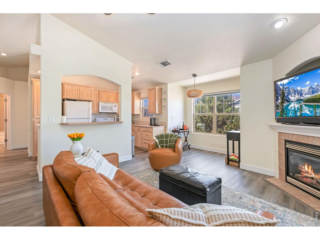 5775 29th Street, Unit 811 Greeley, CO 80634 - Photo 6 of 21 a living room with furniture and a fireplace with wooden floor