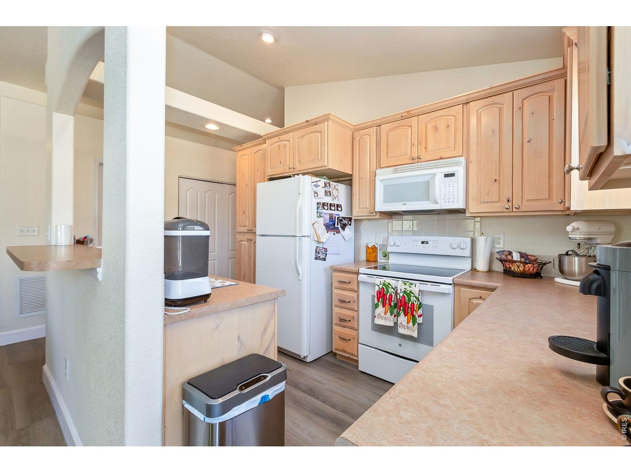 5775 29th Street, Unit 811 Greeley, CO 80634 - Photo 7 of 21 a open kitchen with stainless steel appliances a stove a refrigerator and cabinets