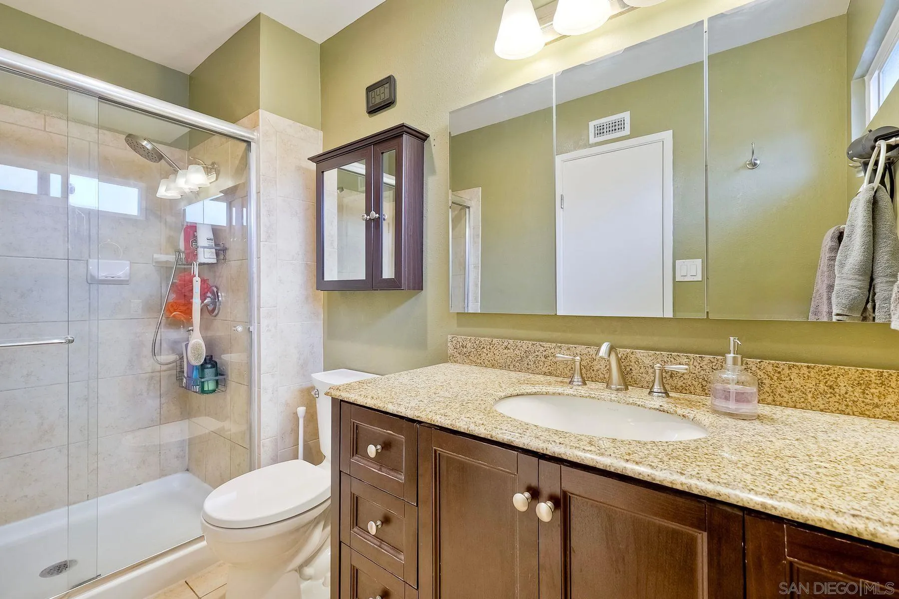 10421 Len Street Santee, CA 92071 - Photo 18 of 34 a bathroom with a granite countertop sink toilet and shower