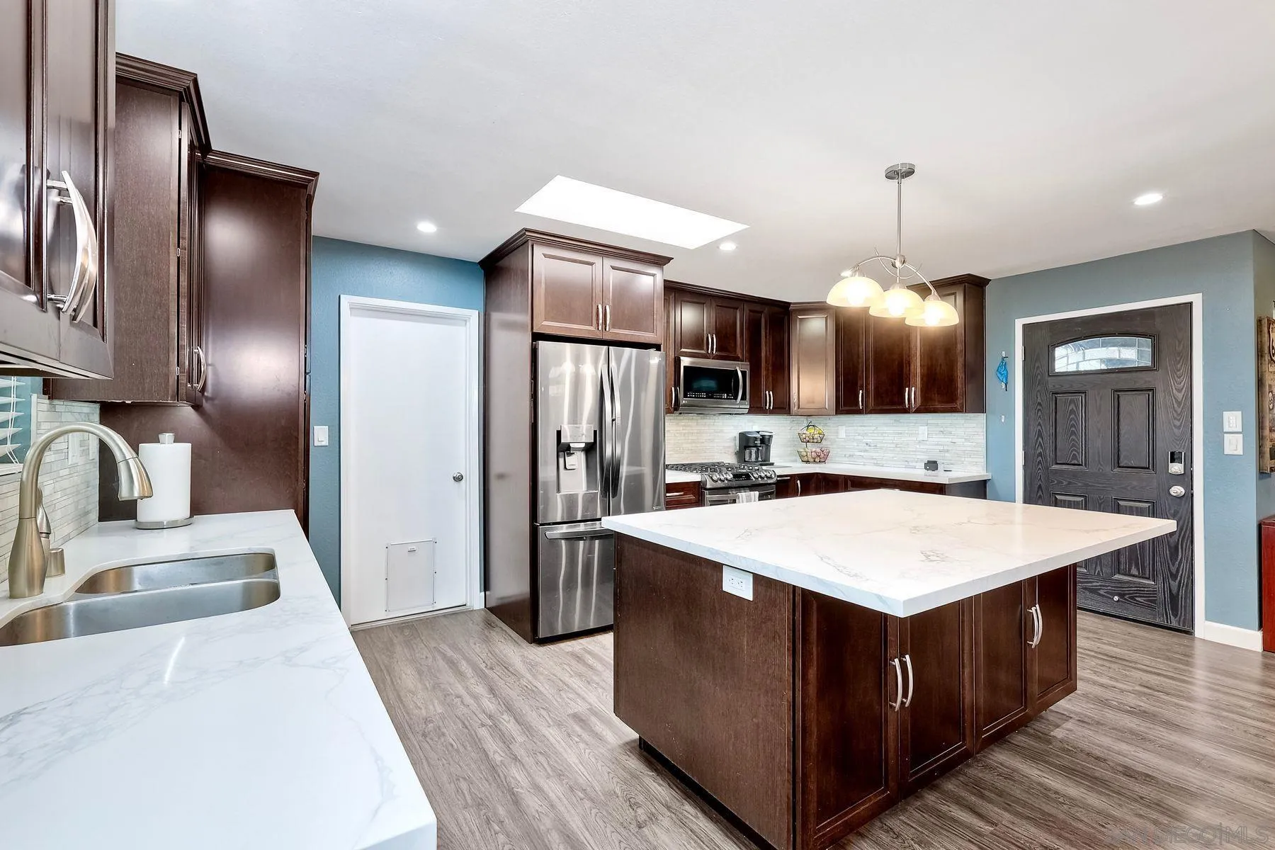 10421 Len Street Santee, CA 92071 - Photo 2 of 34 a kitchen with stainless steel appliances kitchen island granite countertop a sink a stove and a refrigerator