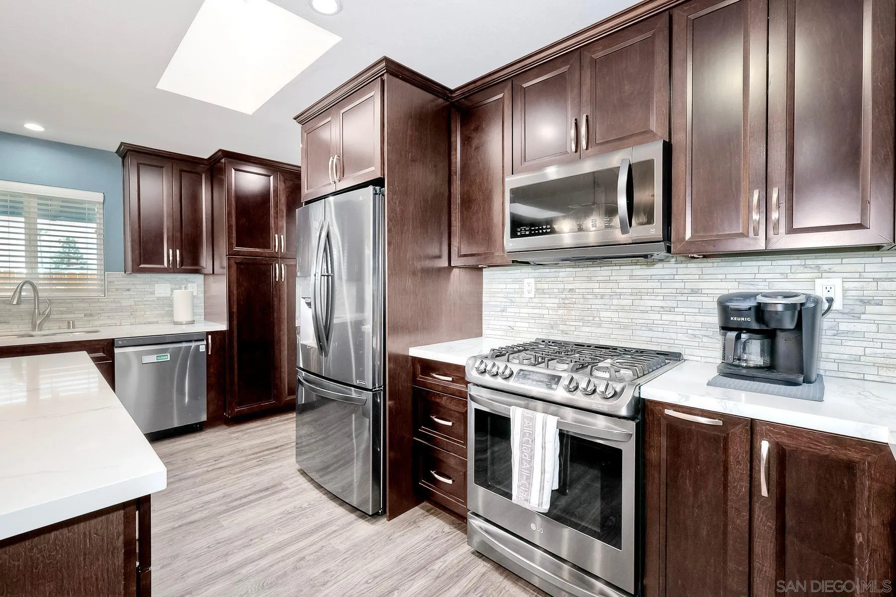 10421 Len Street Santee, CA 92071 - Photo 3 of 34 a kitchen with stainless steel appliances granite countertop a stove microwave and refrigerator
