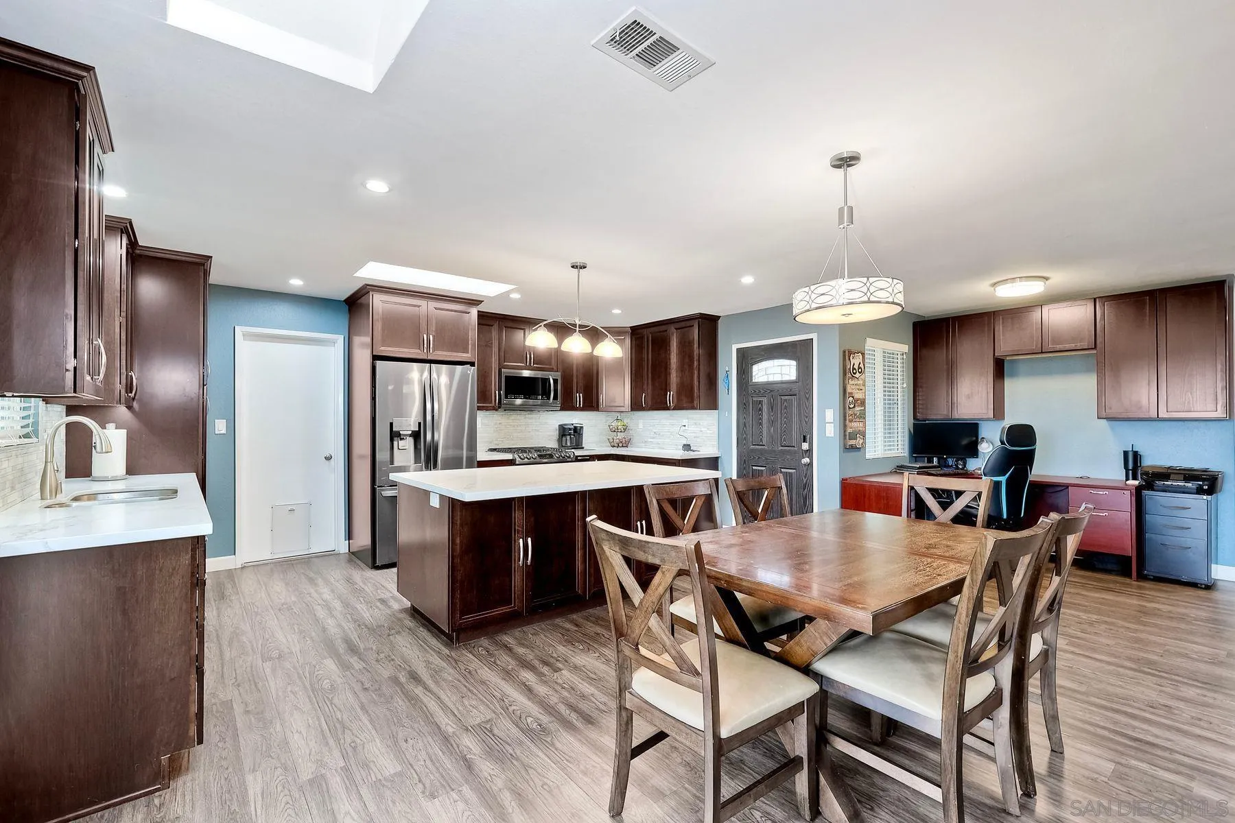 10421 Len Street Santee, CA 92071 - Photo 10 of 34 a view of a dining room and livingroom with furniture wooden floor a chandelier