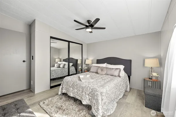 a bedroom with a bed and a mirror