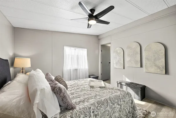 a bedroom with a bed and a painting on the wall