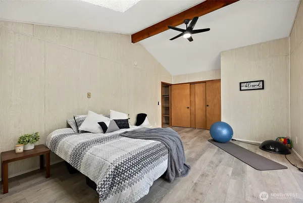 a bedroom with a bed and a chandelier