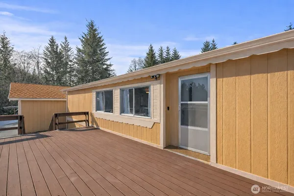 a view of a house with a wooden deck