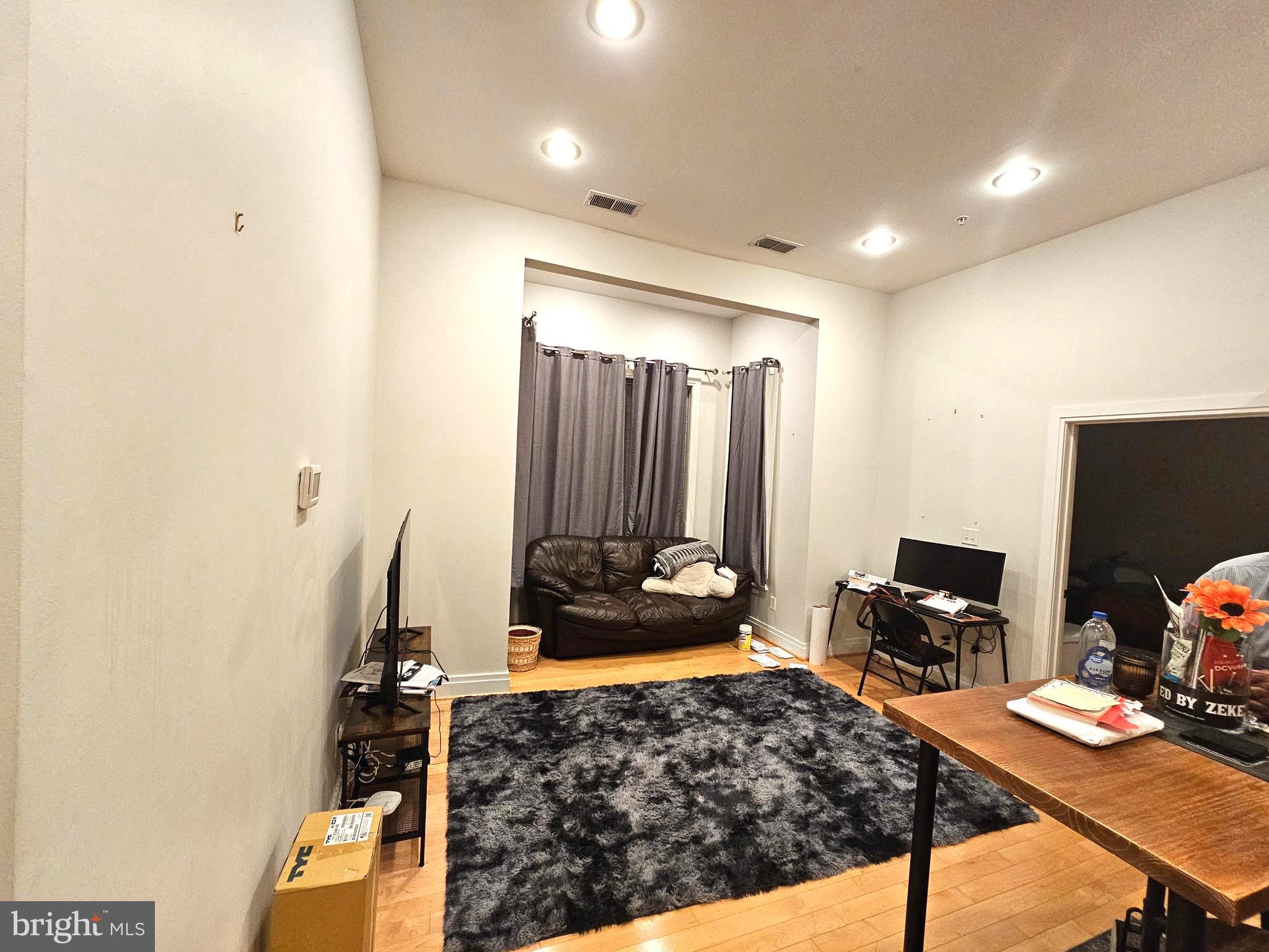 5551 Illinois Avenue Northwest, Unit 202 Washington, DC 20011 - Photo 2 of 3 a bed room with a bed and furniture