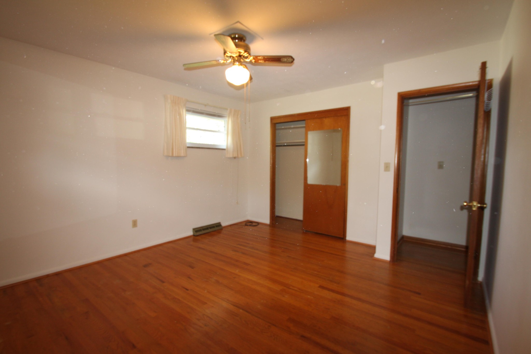 119 North Seneca Road Oak Ridge, TN 37830 - Photo 13 of 20 an empty room with wooden floor and ceiling fan