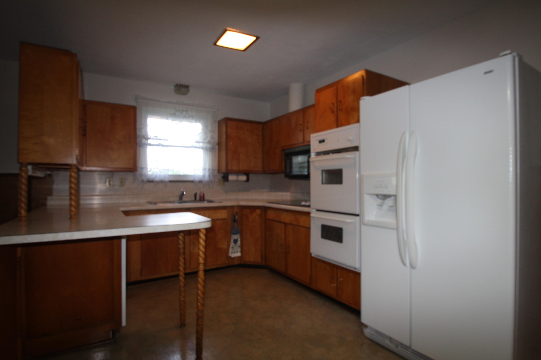 119 North Seneca Road Oak Ridge, TN 37830 - Photo 4 of 20 a kitchen with stainless steel appliances a sink a stove a refrigerator and cabinets