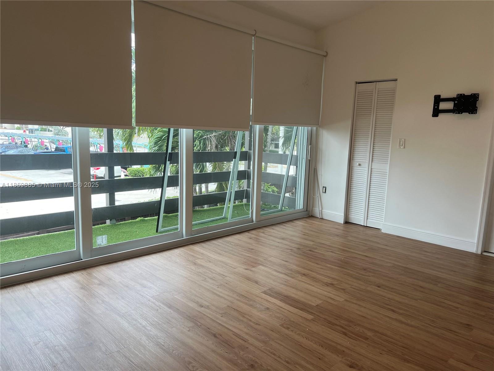 Snapper Creek Townhouses Miami, FL 33173 - Photo 13 of 20 a view of empty room with wooden floor and fan