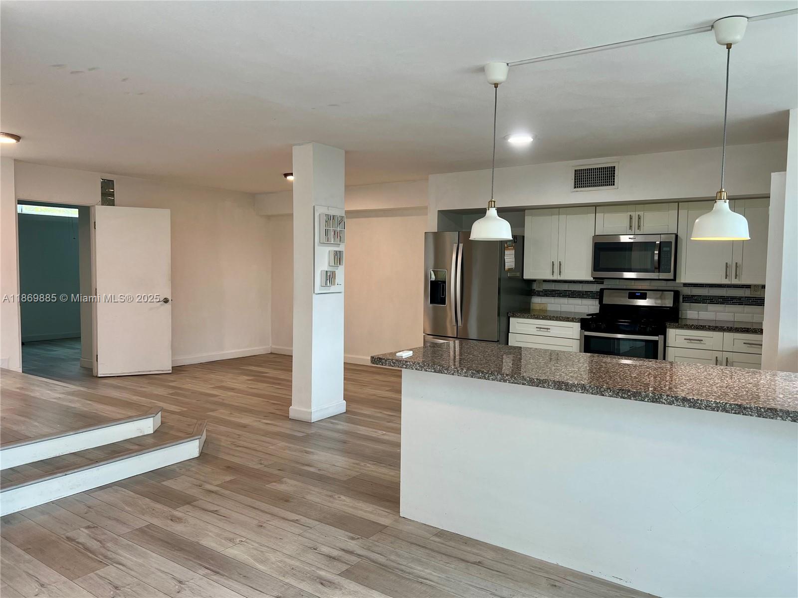 Snapper Creek Townhouses Miami, FL 33173 - Photo 2 of 20 a large kitchen with a large counter top appliances and cabinets