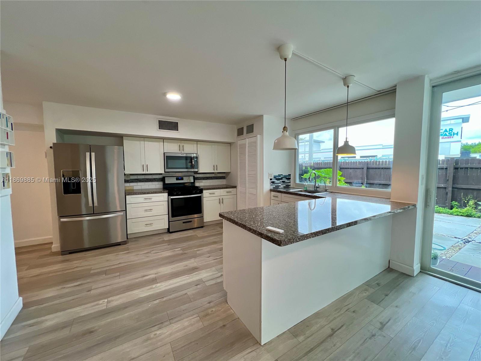 Snapper Creek Townhouses Miami, FL 33173 - Photo 6 of 20 a kitchen with stainless steel appliances granite countertop a refrigerator a sink and a stove