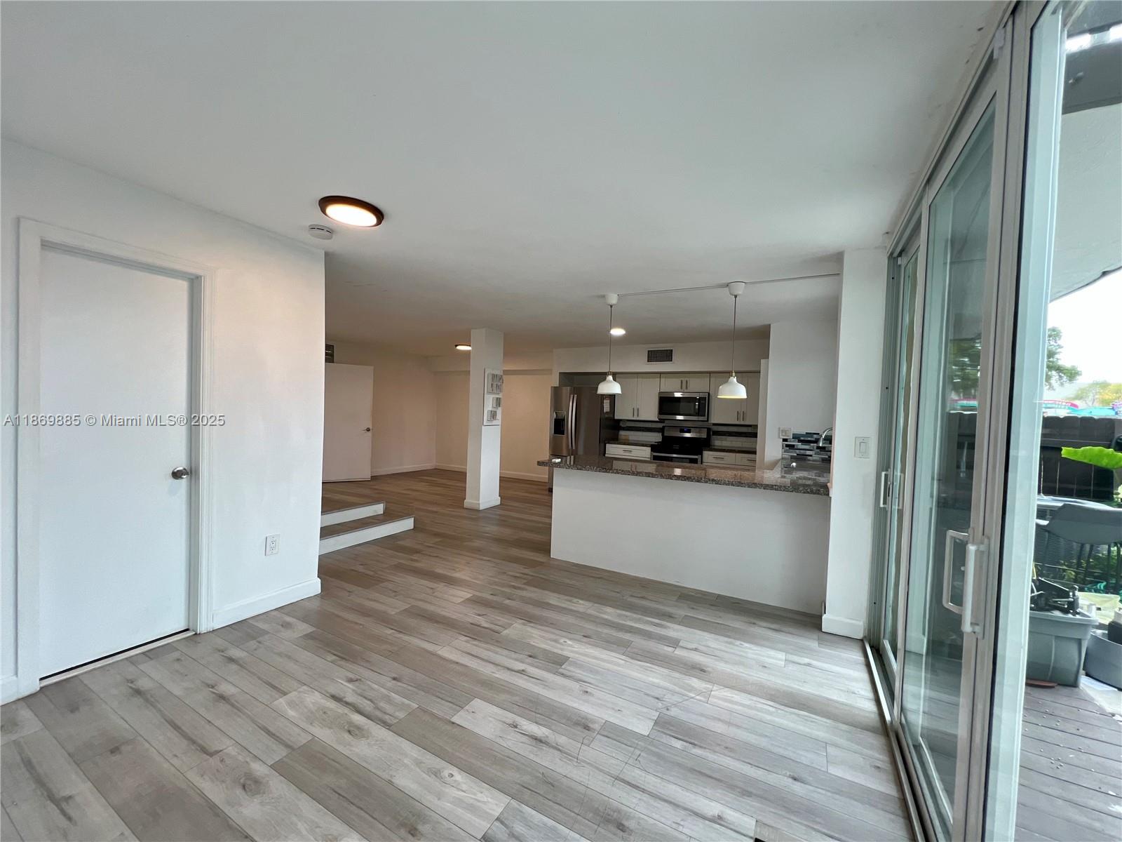 Snapper Creek Townhouses Miami, FL 33173 - Photo 7 of 20 a view of kitchen with refrigerator sink and wooden floor