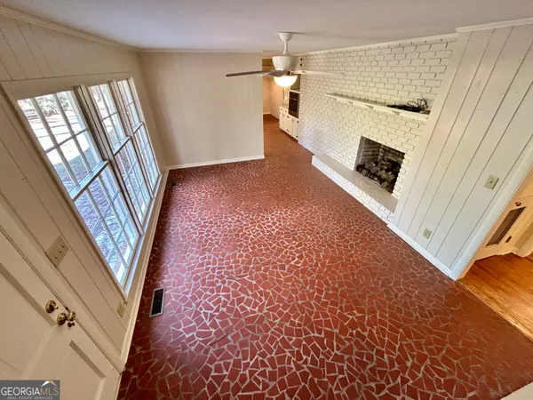 wooden floor in an empty room with a fireplace