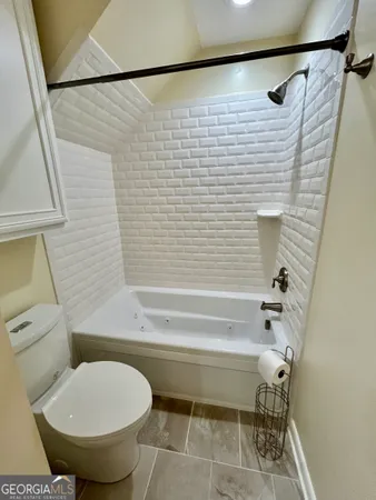 a bathroom with a toilet and a shower