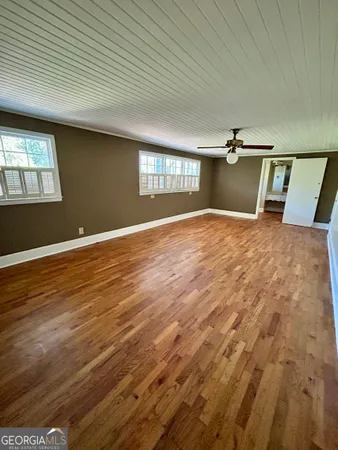 a view of room with window and wooden floor