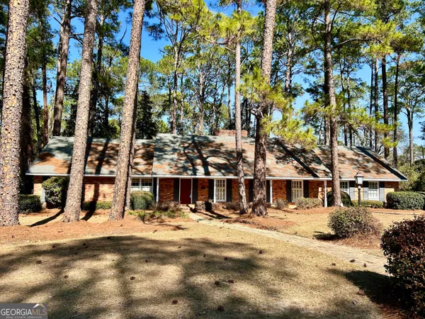 a view of a house with a tree in the background
