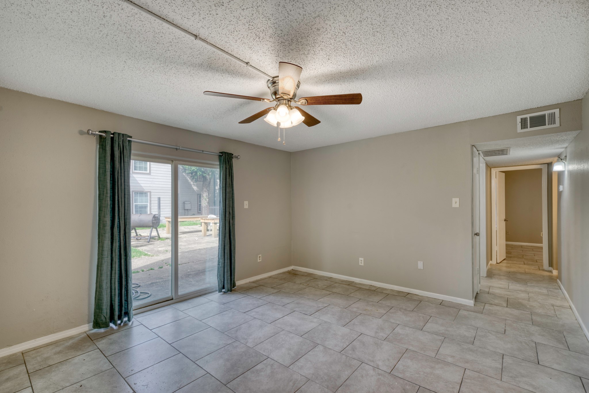 2000 Kazmeier Plaza Bryan, TX 77802 - Photo 13 of 23 an empty room with chandelier fan and windows
